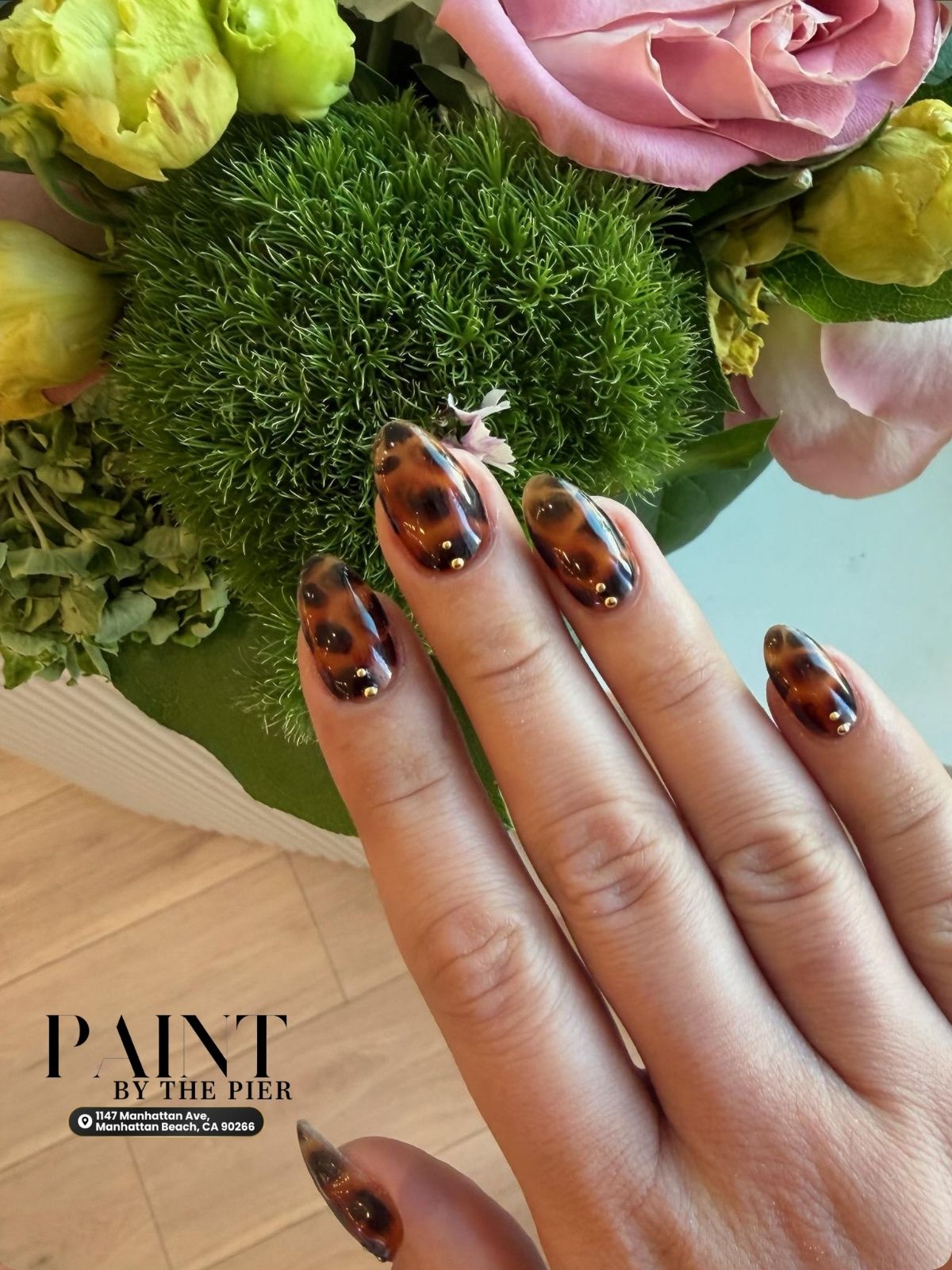 Glossy tortoise shell accent nails with neutral nude gel polish