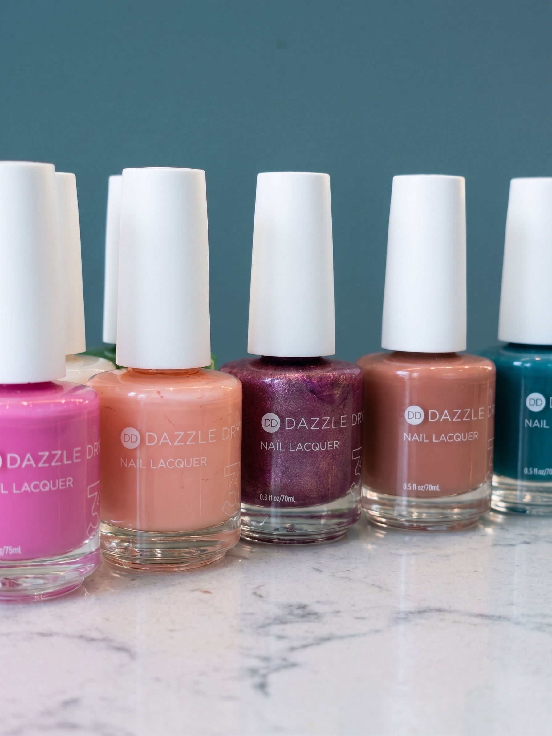 Non-toxic vegan Dazzle Dry nail lacquer bottles at Paint by the Pier nail salon in Manhattan Beach CA